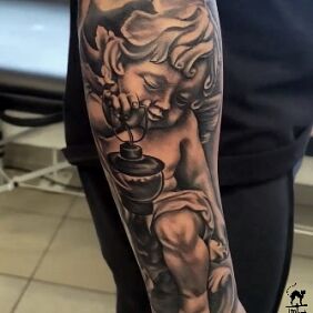 Tattoo Little angel with a lantern On the arm motif: black and gray style: realistic