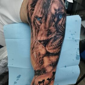 Tattoo Savanna On the arm motif: black and gray style: realistic