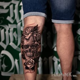 Tattoo Skull in flowers on the calf motif: flowers style: realistic