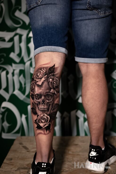 Tattoo Czacha w kwiatach in black and gray motif and realistic style on the leg