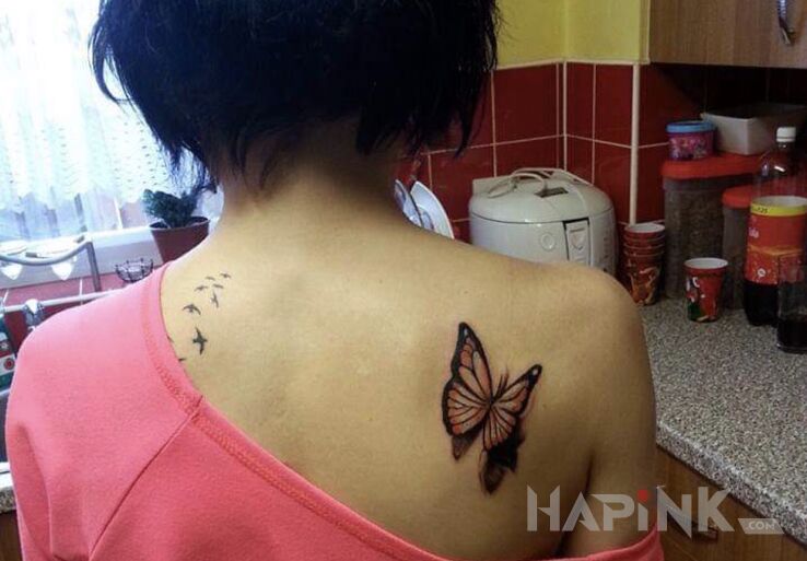 Tattoo Motyl na tyle in butterflies motif and realistic style on the shoulder blades