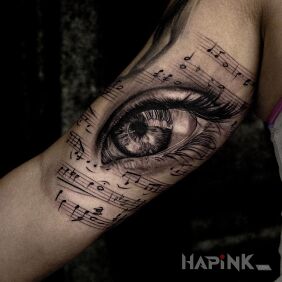 Tattoo Musical eye on the upper arm motif: 3D style: realistic