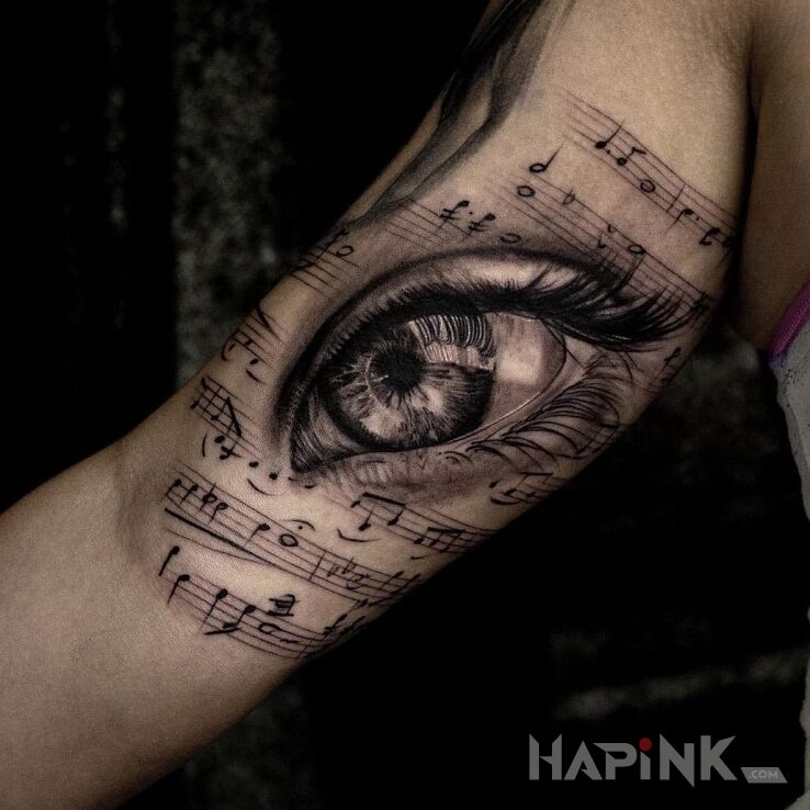 Tattoo Muzykalne oko in 3D motif and realistic style on the upper arm