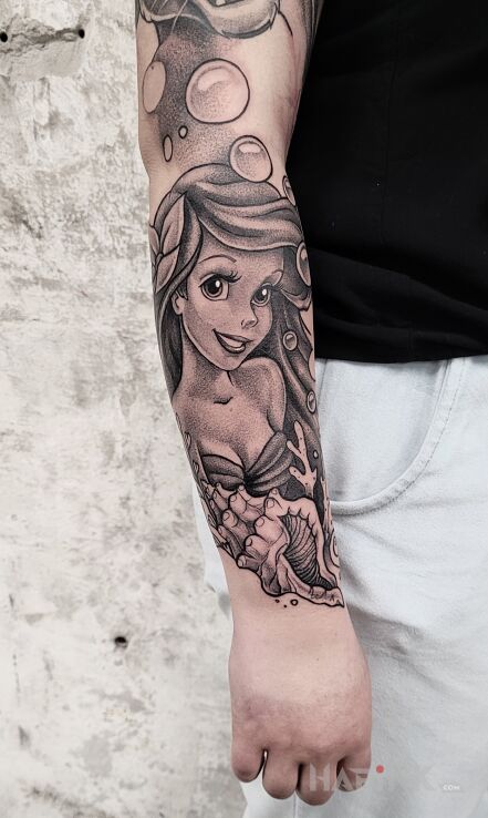 Tattoo Ariel in faces motif and dotwork style On the arm
