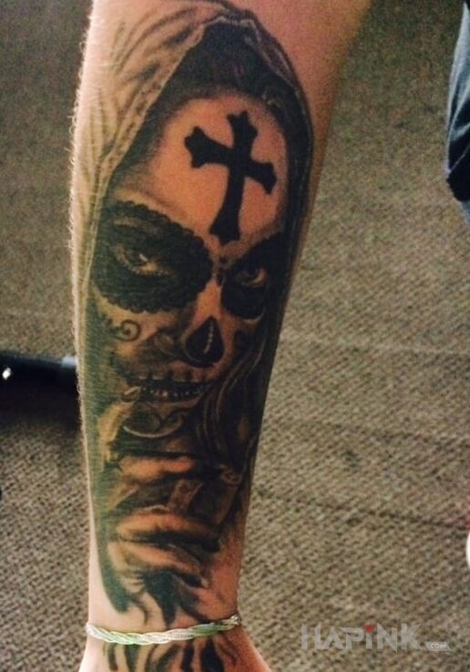 Tattoo Santa muerte in faces motif on the forearm