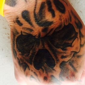 Tattoo Bowl on the hand motif: skulls