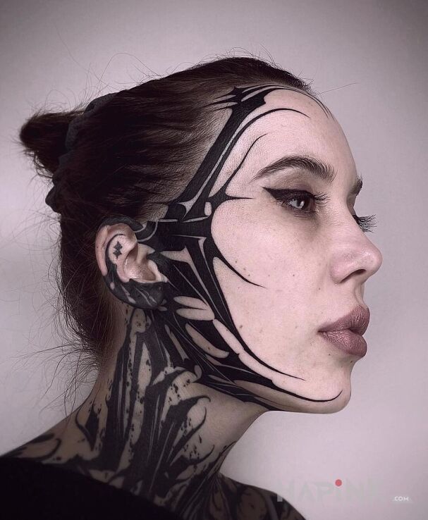 Tattoo Przypomina cyberpunk in black and gray motif and blackwork / blackout style on the face