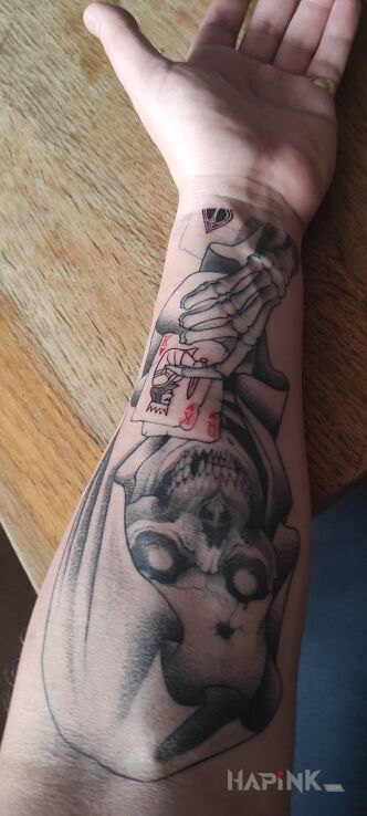 Tattoo Reaper, kostucha z kartami in dark motif and realistic style On the arm
