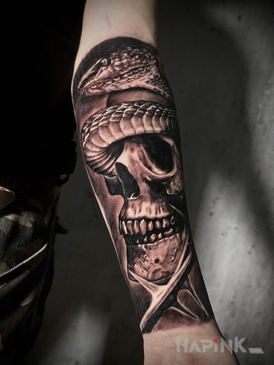Tattoo Czaszka z wężem in black and gray motif and realistic style on the forearm