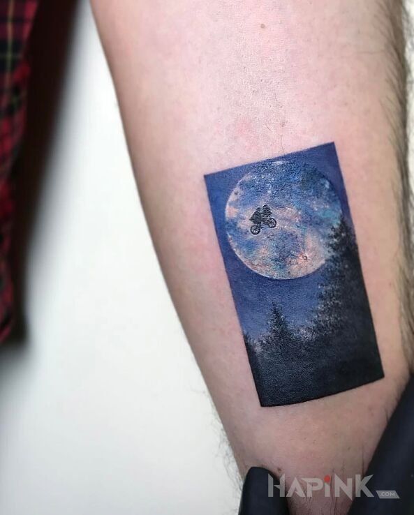 Tattoo ET in characters motif on the forearm