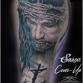 Tattoo Jesus cover on the upper arm motif: cover-up style: realistic