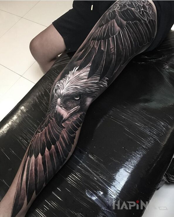 Tattoo Hej sokoly in wings motif and realistic style on the knee