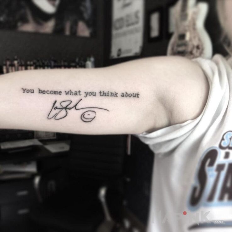 Tattoo You become what you think about in lettering motif on the upper arm
