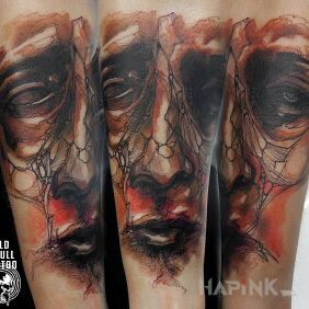 Tattoo Disturbing face On the arm motif: colorful style: abstract