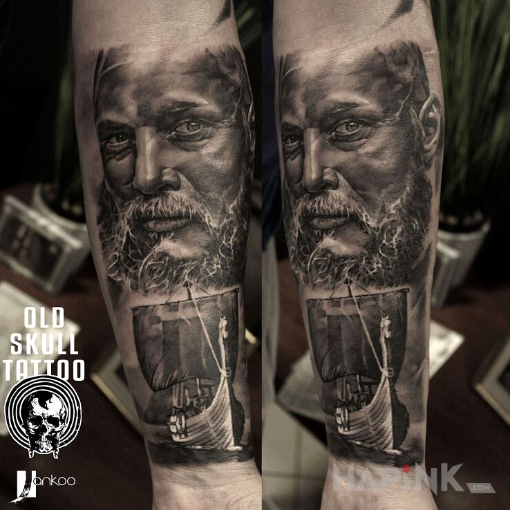 Tattoo Viking in faces motif and realistic style On the arm