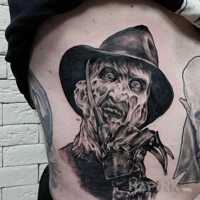 Tattoo Freddy on the ribs motif: black and gray style: realistic