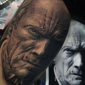 Tattoo Clint Eastwood on the upper arm motif: characters style: realistic