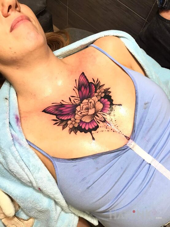 Tattoo Motyl in flowers motif and graphic / illustrative style on the chest
