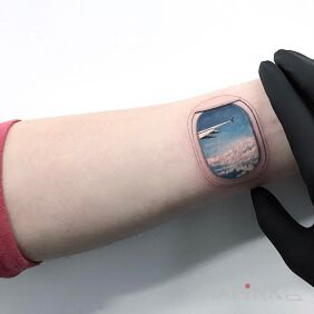 Tattoo Window on the forearm style: realistic