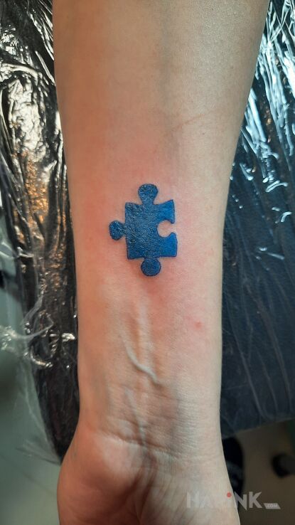 Tattoo Autismo in other motif and minimalistic style On the arm