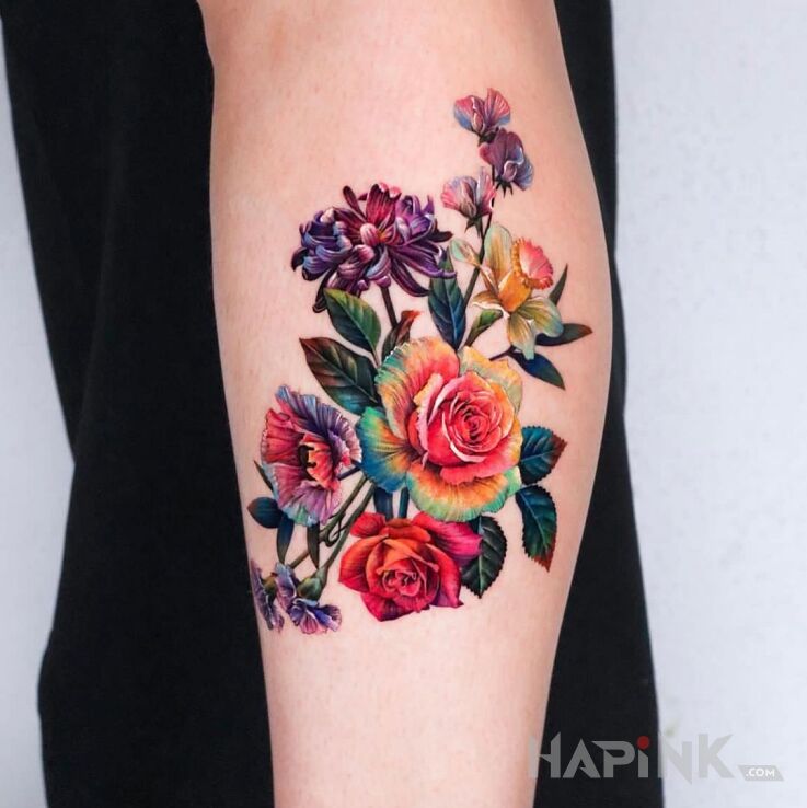 Tattoo Róże w kolorach tęczy in flowers motif and realistic style On the arm