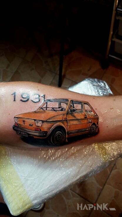 Tattoo Fiat in realistic style on the forearm