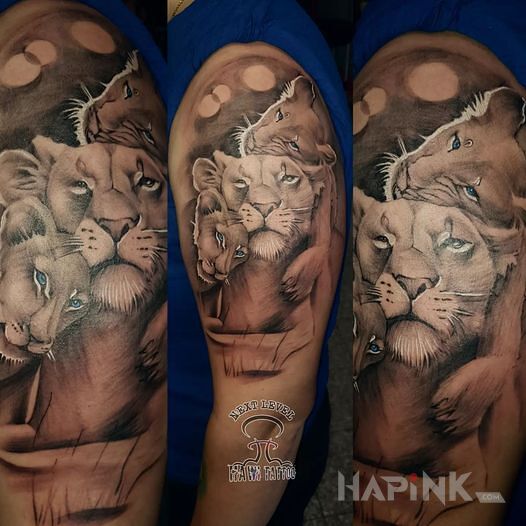Tattoo Lwia rodzina in animals motif and realistic style on the upper arm