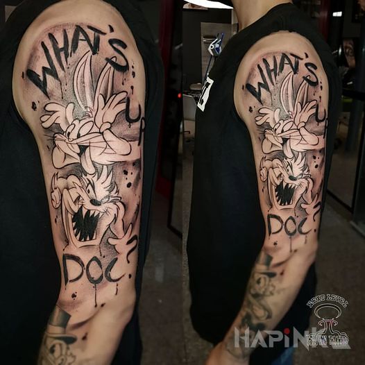 Tattoo Disney in black and gray motif and cartoon / comic book style On the arm
