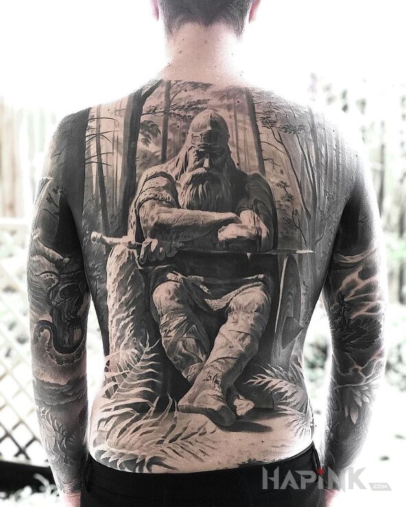 Tattoo Wiking w lesie in black and gray motif and realistic style on the back