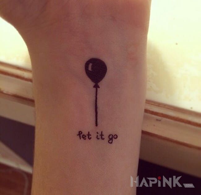 Tattoo Let it go in lettering motif on the forearm