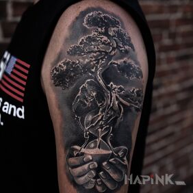 Tattoo Bonsai tree on the upper arm motif: black and gray style: realistic