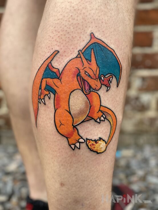 Tattoo Pokemon charizard in colorful motif and cartoon / comic book style on the leg