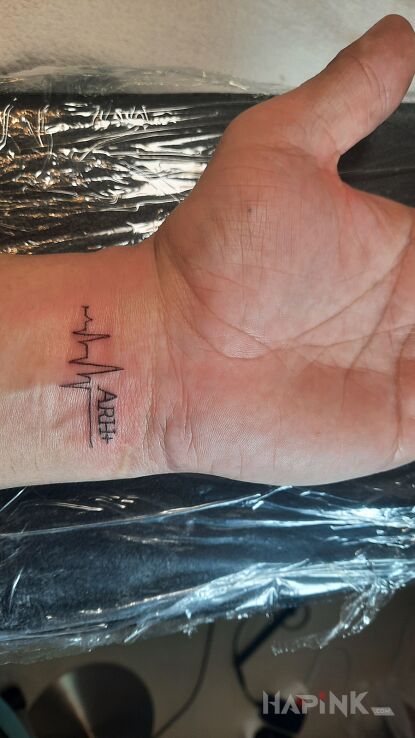 Tattoo Linia życia in black and gray motif and minimalistic style On the arm
