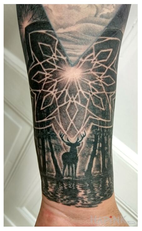 Tattoo Sacred Geometry in black and gray motif and geometric style on the forearm