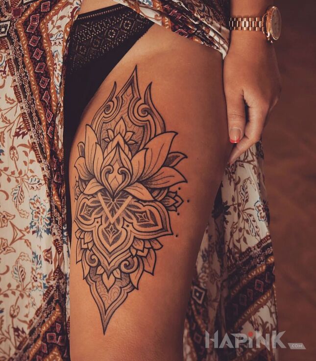 Tattoo Kwiat lotosu in mandalas motif and graphic / illustrative style on the thigh