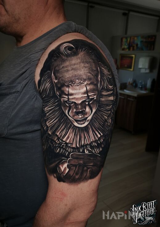 Tattoo Pennywise in characters motif and realistic style On the arm