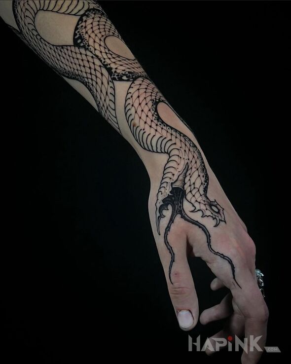Tattoo Wężyk in dark motif and graphic / illustrative style On the arm
