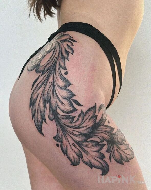 Tattoo Kawał liścia in floral motif and graphic / illustrative style on the thigh