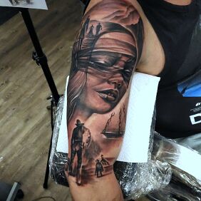 Tattoo Themis collage on the upper arm motif: faces style: realistic