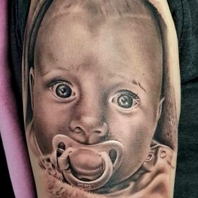 Tattoo Baby portrait on the forearm motif: faces style: realistic