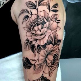 Tattoo Floral composition on biceps on the upper arm motif: black and gray style: graphic / illustrative