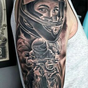 Tattoo Motorcyclist On the arm motif: black and gray style: realistic