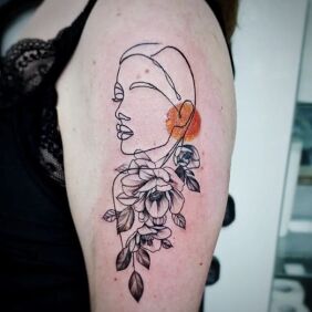 Tattoo Nature on the upper arm motif: faces style: graphic / illustrative