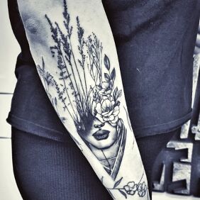 Tattoo Portrait with a meadow On the arm motif: flowers style: graphic / illustrative
