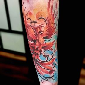 Tattoo Phoenix On the arm motif: colorful style: Watercolor