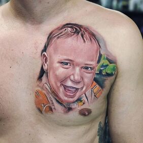 Tattoo Portrait of a son on the chest motif: colorful style: realistic