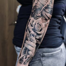 Tattoo Rose in hand on the forearm motif: flowers style: realistic