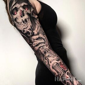Tattoo Undead on the upper arm motif: skulls style: graphic / illustrative