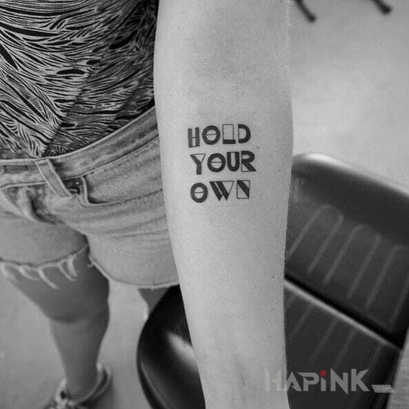 Tattoo Hold your own in lettering motif on the forearm