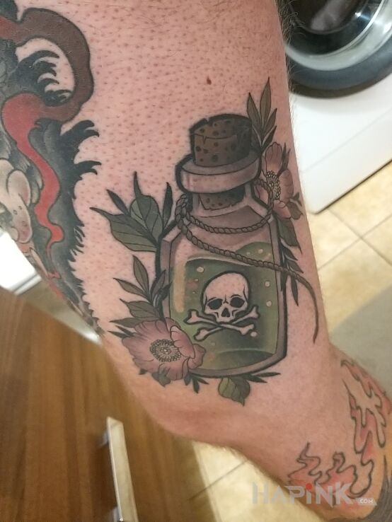 Tattoo Poison tattoo in flowers motif and graphic / illustrative style on the thigh
